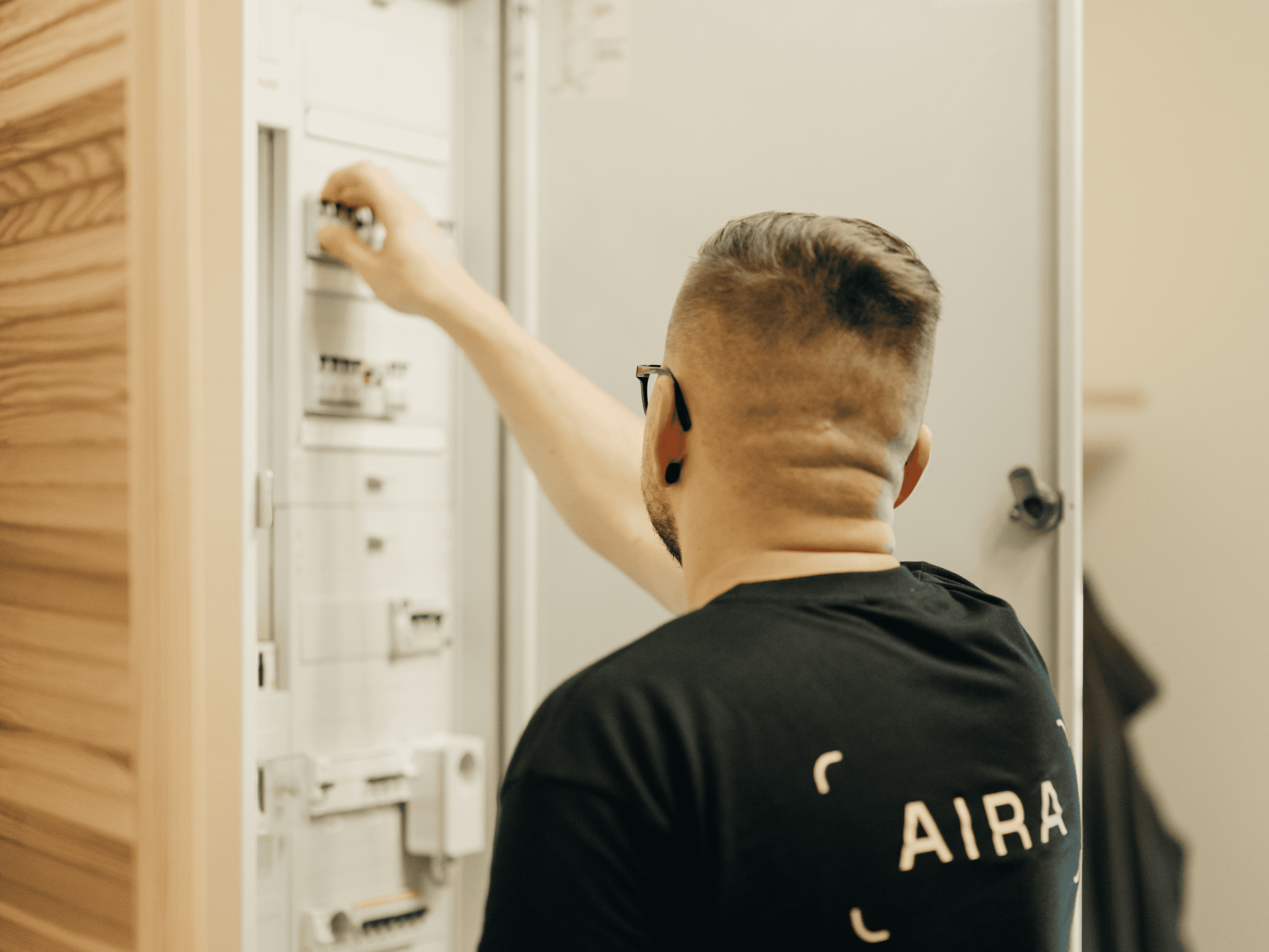 An Aira employee at a fuse box